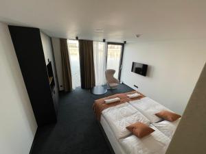 a hotel room with a bed and a television at Ponton Rooms in Bratislava