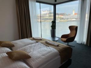 a hotel room with a bed and a large window at Ponton Rooms in Bratislava