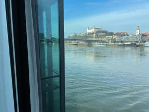 a view of the water from a window of a ship at Ponton Rooms in Bratislava