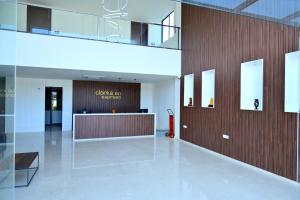 a lobby with a reception desk in a building at Clarks Inn Express, KRS road-Mandya, Mysore in Mysore