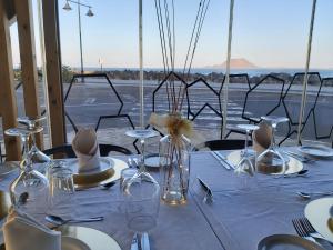 a table with a white table cloth and hats on it at Dunas Club - Hotel & Apartamentos in Corralejo
