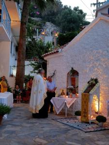 a couple of priests standing outside of a building at Lilly's Seaview Retreat Cottage in Avlákia +29 photos