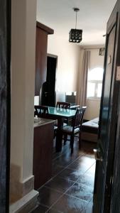 a living room with a table and a dining room at Relax Unit In Porto Sharm Resort in Sharm El Sheikh