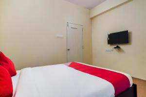 1 dormitorio con cama blanca y manta roja en Alpine glow Zenith en Hyderabad