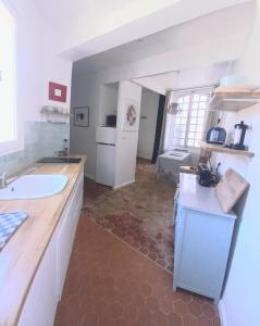 a kitchen with a sink and a counter top at Maison Passère in Forcalquier