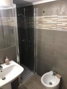 a bathroom with a shower and a toilet and a sink at B&B Nonno Walter in Torre del Greco +13 photos