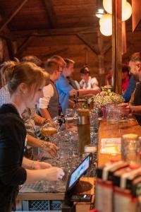 a group of people sitting at a table with a laptop at Wies'n Camp in Munich
