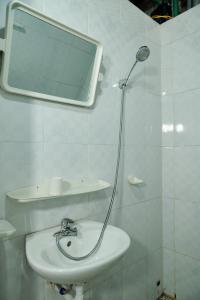 a bathroom with a sink and a mirror on the wall at Rainbow House Ha Giang in Ha Giang