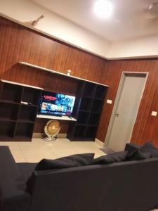 un soggiorno con divano e TV a schermo piatto di HB816 -Cyberjaya-Netflix-Wifi-Parking, 3036 a Cyberjaya