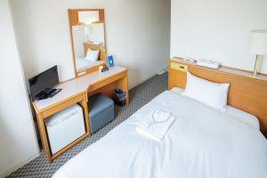 Postel nebo postele na pokoji v ubytování Hotel Casabella Inn Kobe