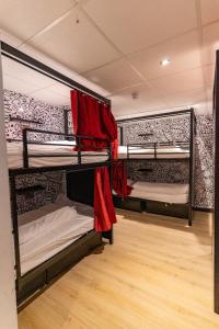 two bunk beds in a room with a wooden floor at Hostelle - women only hostel London in London