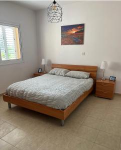 a bedroom with a bed and two night stands at Mountain View Apartment - Polis in Polis Chrysochous