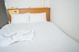 Postel nebo postele na pokoji v ubytování Hotel Casabella Inn Kobe