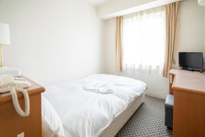 Postel nebo postele na pokoji v ubytování Hotel Casabella Inn Kobe