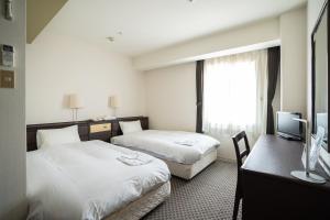 Postel nebo postele na pokoji v ubytování Hotel Casabella Inn Kobe