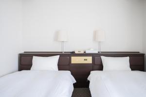 Postel nebo postele na pokoji v ubytování Hotel Casabella Inn Kobe