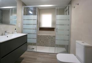 a bathroom with a shower and a toilet and a sink at Casa Sierra de Guara in Adahuesca +49 photos
