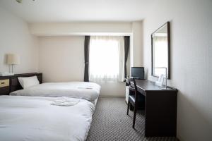 Postel nebo postele na pokoji v ubytování Hotel Casabella Inn Kobe