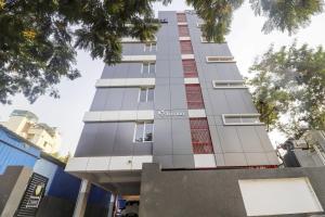 a tall building with red and white windows at OYO Townhouse 78364 Townhouse 388 Madhapur Near Shilparamam in Kondapur