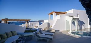 a patio with chairs and a swimming pool at Acro Blue Luxury Villas in Akrotiri