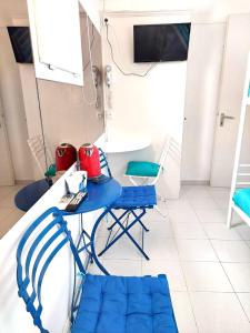 a blue table and chairs in a room with a table at Seatincenter Rooms in Mýkonos City