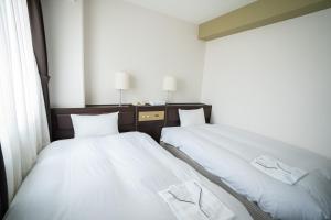 Postel nebo postele na pokoji v ubytování Hotel Casabella Inn Kobe