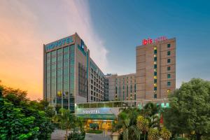 a hotel with a sign on top of a building at ibis Bengaluru Outer Ring Road in Bangalore