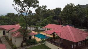 an aerial view of a house with pink roofs at Tiara Resort Mandwa in Alibaug
