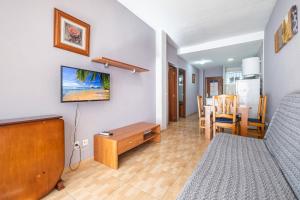 a living room with a bed and a dining room at Apartamentos Lepanto 21 Levante Area in Benidorm