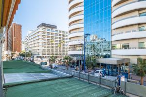 a tennis court in a city with buildings at Apartamentos Lepanto 21 Levante Area in Benidorm