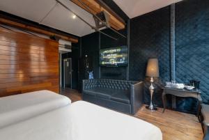 a bedroom with a bed and a couch and a table at Boutique 56 in Liverpool