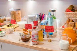 a counter topped with lots of different types of food at Garni Schmiedhof in Naturno