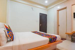 a bedroom with a bed in a room at FabHotel Bliss Inn in Prayagraj