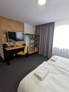 Łóżko lub łóżka w pokoju w obiekcie Gold Hotel