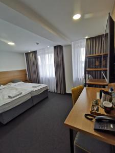 Łóżko lub łóżka w pokoju w obiekcie Gold Hotel