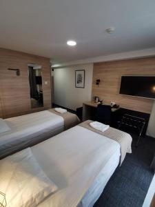 Łóżko lub łóżka w pokoju w obiekcie Gold Hotel