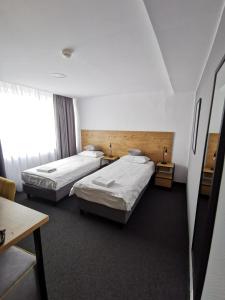 a hotel room with two beds and a window at Gold Hotel in Złotoryja