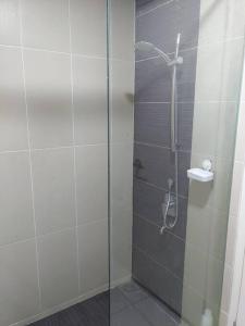 a bathroom with a shower with a glass door at KA1707 - Cyberjaya-Netflix-Wifi- Parking, 1005 in Cyberjaya