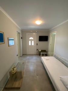 a room with a bed and a table and a tv at Dina’s house in Argostoli