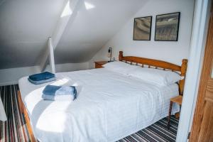 a bedroom with a large white bed in a attic at Beachside Guesthouse in St Ives