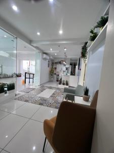 a living room with a table and chairs in a room at Cebu Mini Hotel in Cebu City