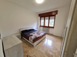 a bedroom with a bed and a window in it at Appartamento La finestra sul Parco in Dalmine