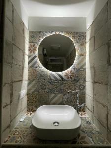 a bathroom with a white sink and a mirror at LA CASA DI NONNA TERESA in Fasano +38 photos