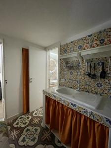 a bathroom with a large sink and a shower at LA CASA DI NONNA TERESA in Fasano