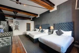 a room with three beds in a room at Boutique 56 in Liverpool