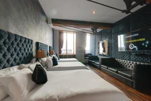 a hotel room with two beds and a couch at Boutique 56 in Liverpool