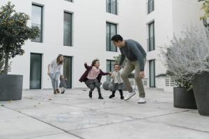 a group of people playing with chalk on the sidewalk at Elke Spa Hotel in Sant Feliu de Guíxols