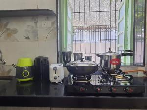 a kitchen counter with a stove with a pot on it at OSI Apartments Khar West in Mumbai