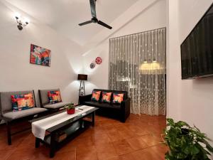 a living room with a couch and a table at By The Beach Goa INFINITY in Benaulim