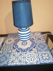 a blue and white lamp sitting on top of a table at La Playa di Ponente in Cagliari